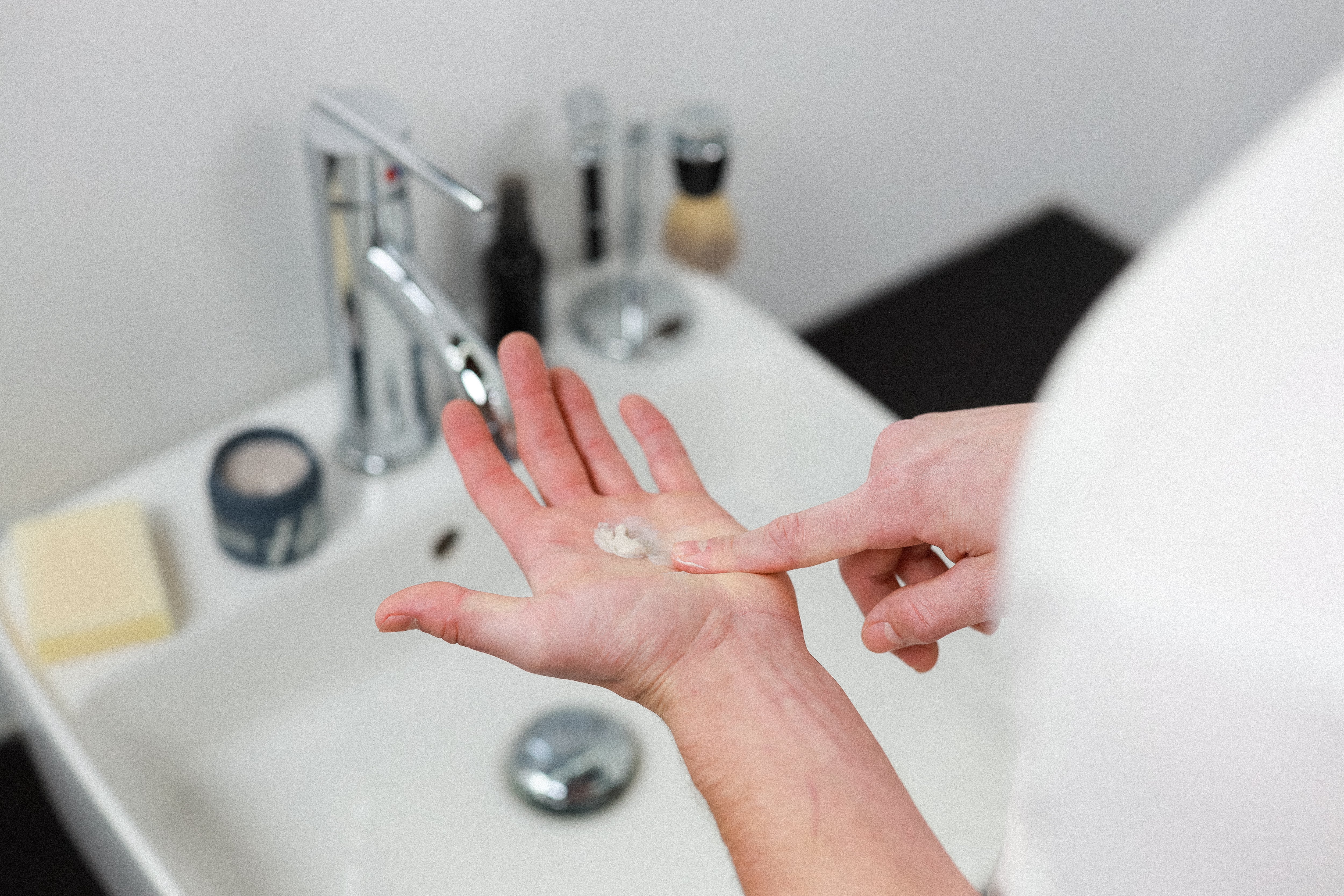 Man with a small amount of pomade on his palm